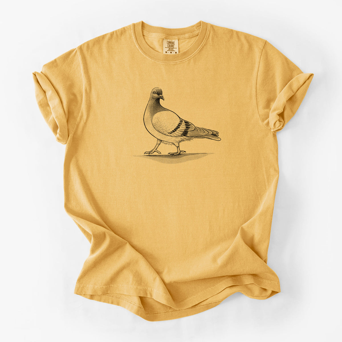 Golden wheat yellow Comfort Colors t-shirt laid flat, printed with a black ink illustration of a pigeon standing.