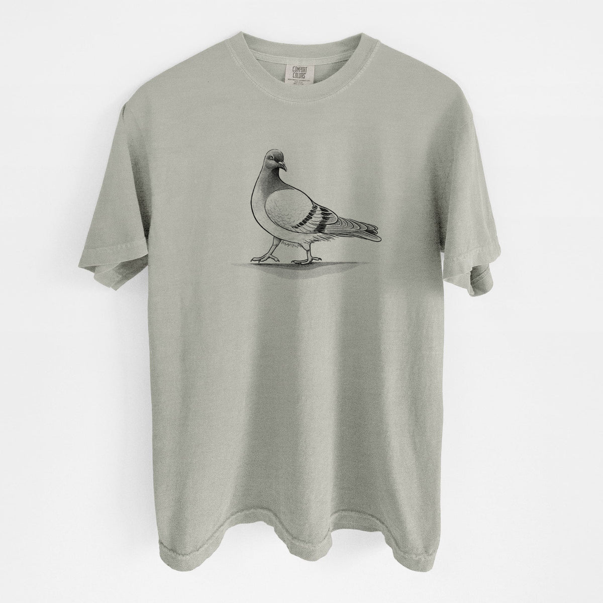 Sandstone beige Comfort Colors t-shirt laid flat, printed with a black ink illustration of a pigeon standing.