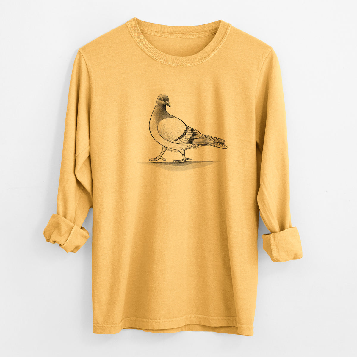 Golden wheat yellow Comfort Colors long sleeve shirt laid flat with the cuffs rolled, printed with a black ink illustration of a pigeon standing.