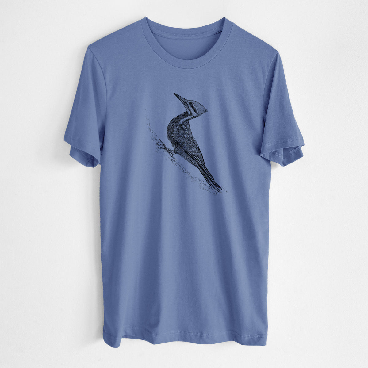Blue bell lightweight cotton t-shirt laid flat, printed with a black ink illustration of a pileated woodpecker clinging to a tree trunk.