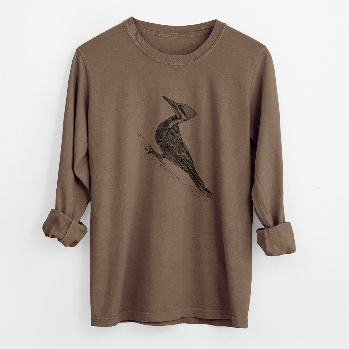 Espresso brown Comfort Colors long sleeve shirt laid flat with the cuffs rolled, printed with a black ink illustration of a pileated woodpecker clinging to a tree trunk.