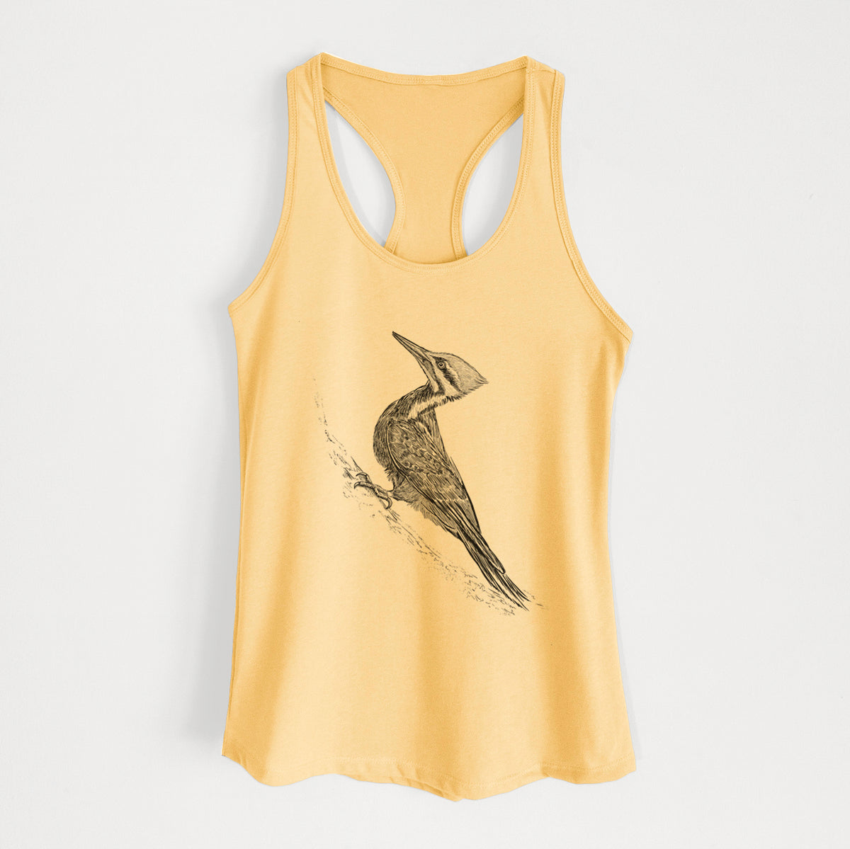 Banana cream women's racerback tank top laid flat, printed with a black ink illustration of a pileated woodpecker clinging to a tree trunk.
