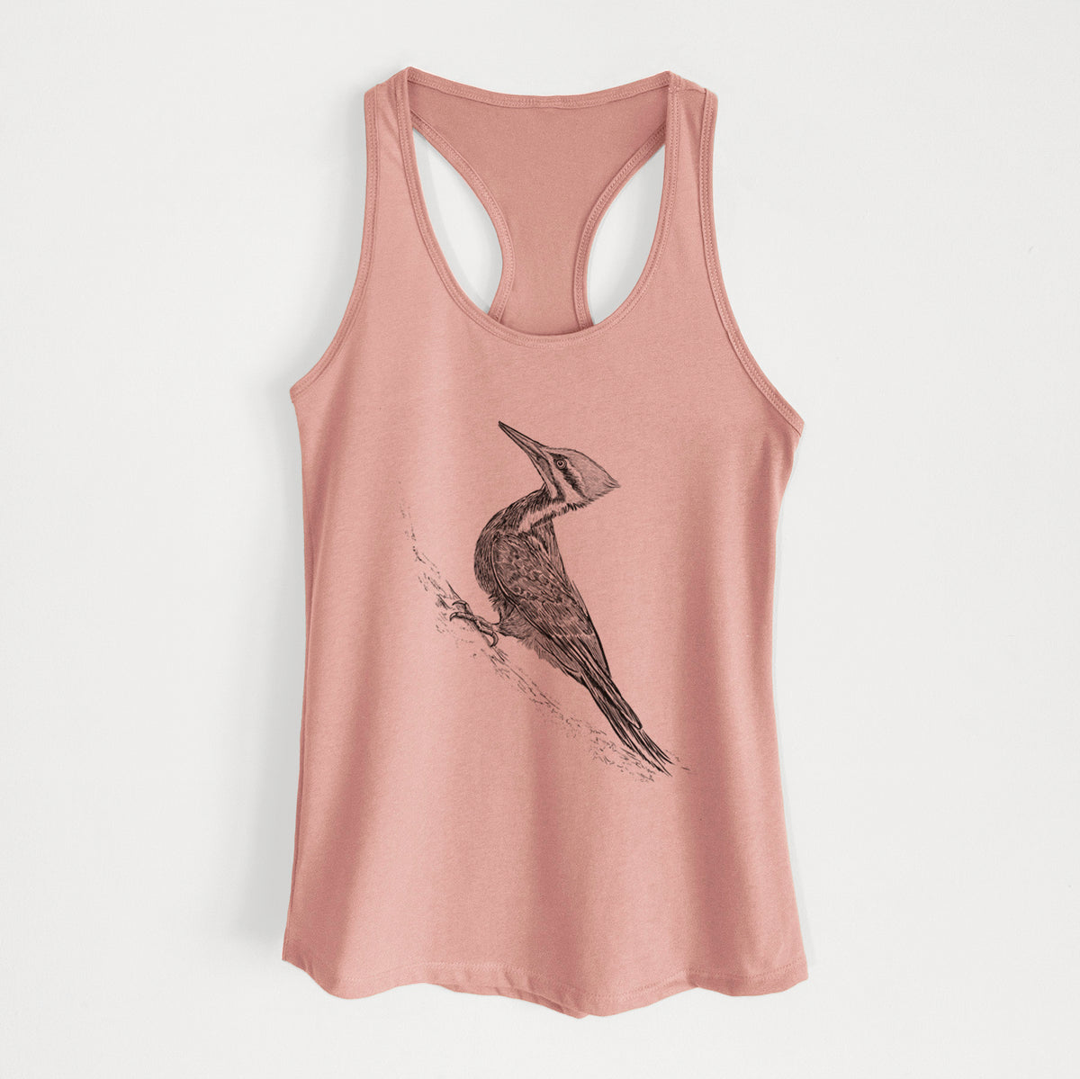 Desert pink women's racerback tank top laid flat, printed with a black ink illustration of a pileated woodpecker clinging to a tree trunk.