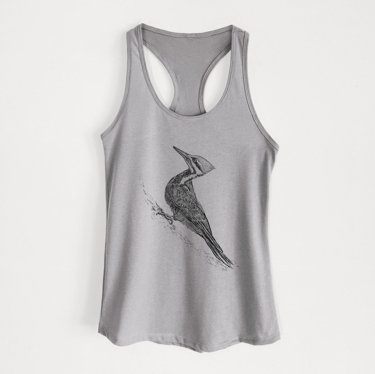 Heather grey women's racerback tank top laid flat, printed with a black ink illustration of a pileated woodpecker clinging to a tree trunk.