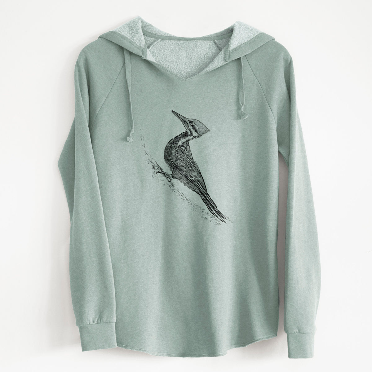 Sage green women's Cali Wave hooded sweatshirt laid flat, printed with a black ink illustration of a pileated woodpecker clinging to a tree trunk.