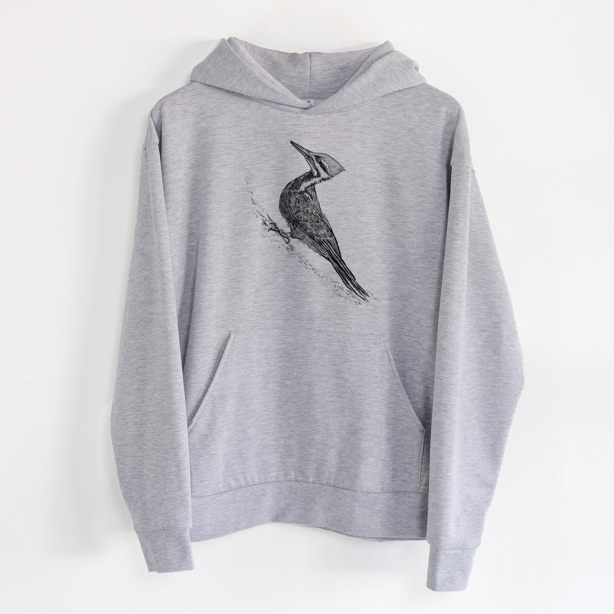 Pileated Woodpecker - Dryocopus pileatus - Statement Midweight Hoodie in Heather Grey, hanging on a white wall, with a front kangaroo pocket and no drawcords.