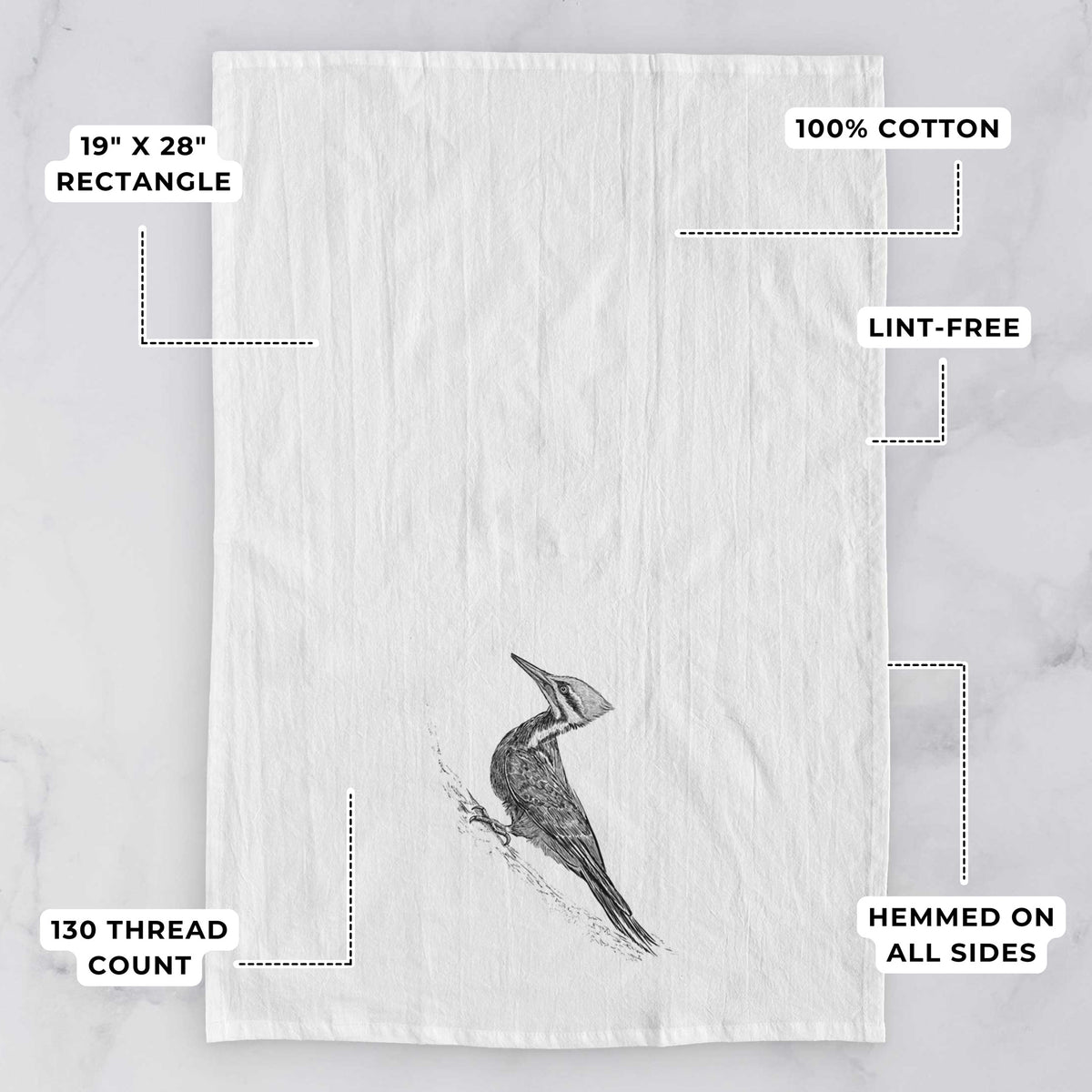 White tea towel printed with a black ink illustration of a pileated woodpecker clinging to a tree trunk, with feature labels: 19 by 28 inch rectangle, 100% cotton, lint-free, 130 thread count, hemmed on all sides.