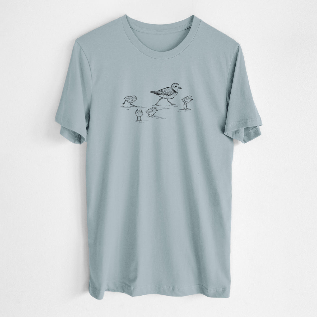 Vintage denim lightweight cotton t-shirt laid flat, printed with a black ink sketch of a piping plover with its chicks on the sand.