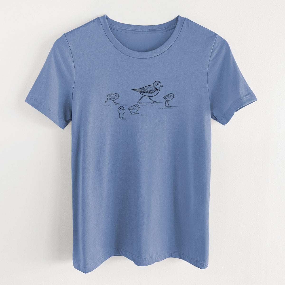 Blue bell women's relaxed fit cotton t-shirt laid flat, printed with a black ink sketch of a piping plover with its chicks on the sand.