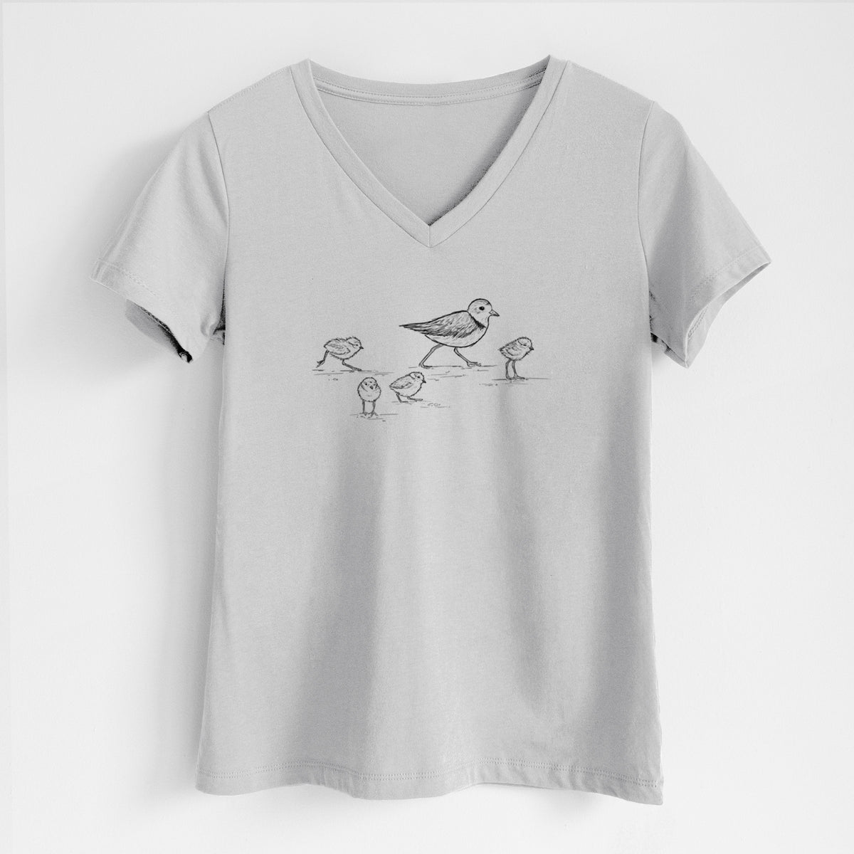 Lunar grey women's relaxed fit cotton V-neck t-shirt laid flat, printed with a black ink sketch of a piping plover with its chicks on the sand.