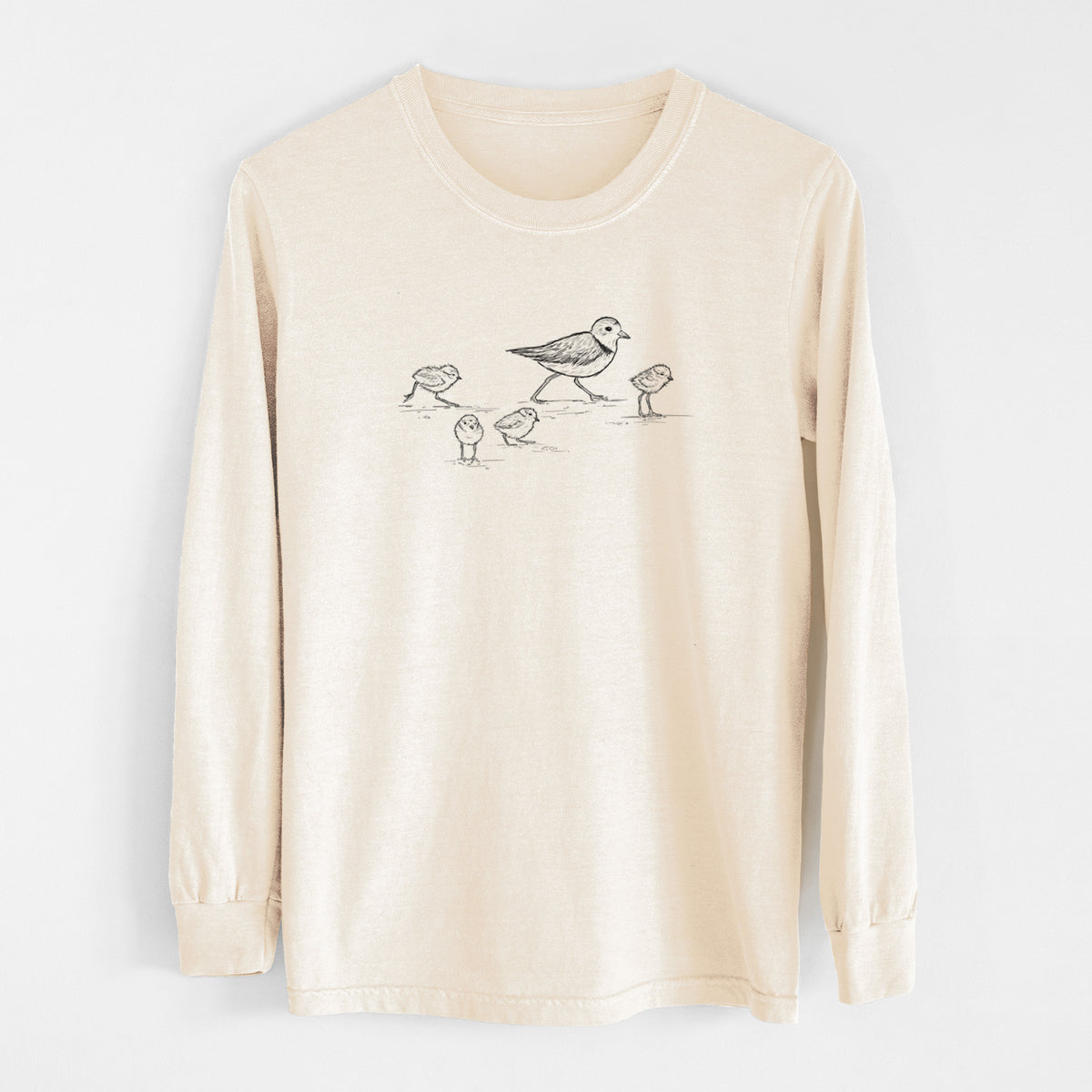 Ivory Comfort Colors long sleeve shirt laid flat, printed with a black ink sketch of a piping plover with its chicks on the sand.