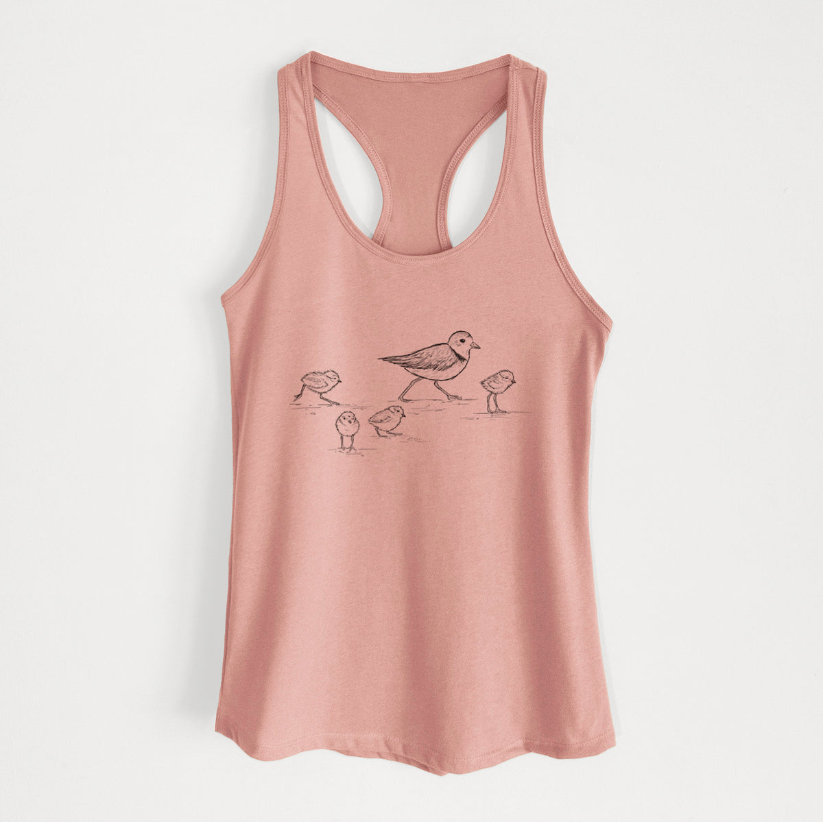 Desert pink women's racerback tank top laid flat, printed with a black ink sketch of a piping plover with its chicks on the sand.