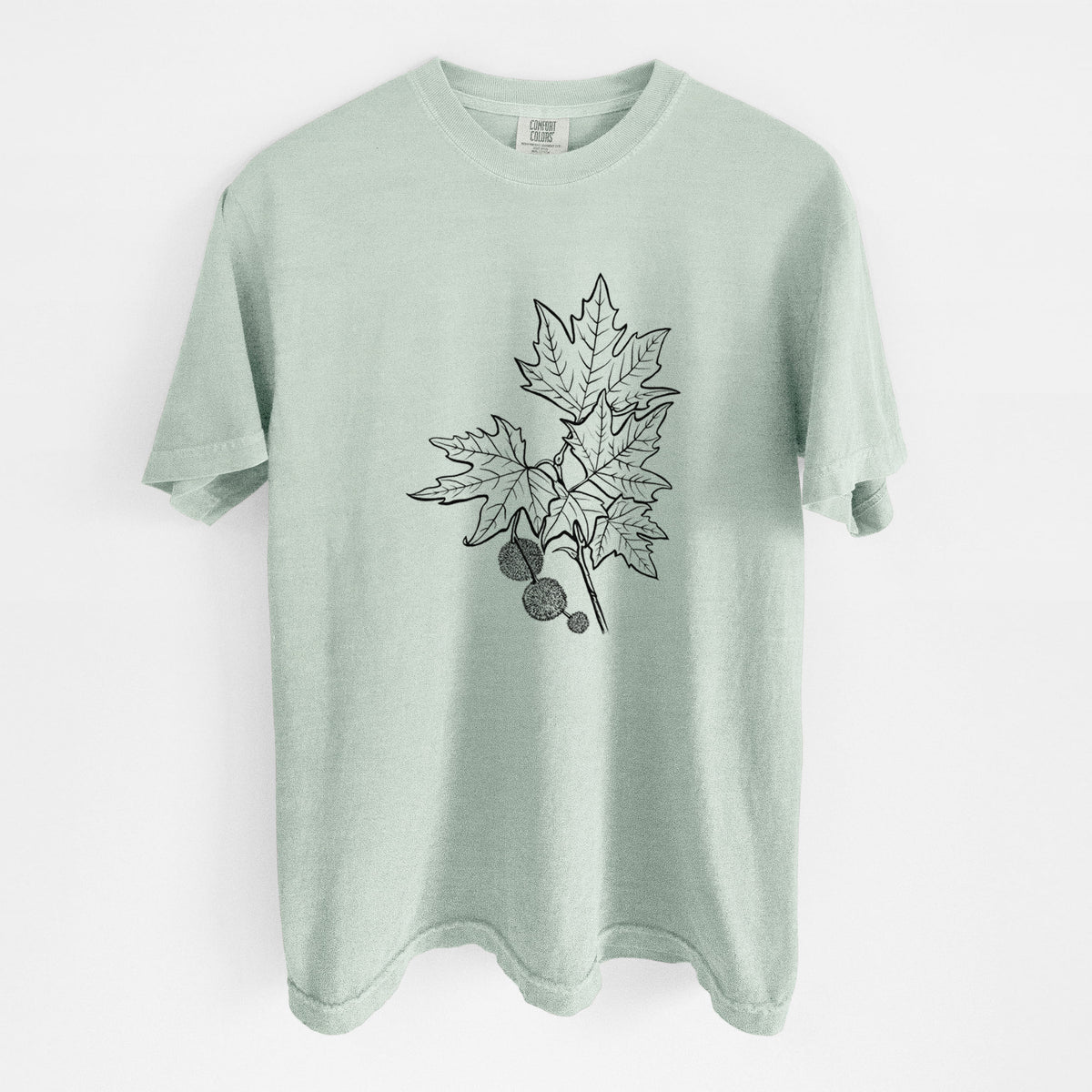 Bay green Comfort Colors t-shirt laid flat, printed with a black ink illustration of an oriental plane tree branch with lobed leaves and round seed balls.