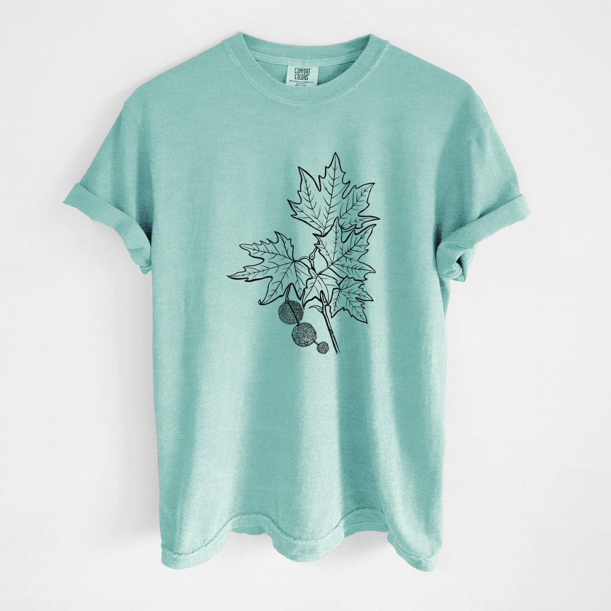 Chalky mint Comfort Colors t-shirt laid flat, printed with a black ink illustration of an oriental plane tree branch with lobed leaves and round seed balls.