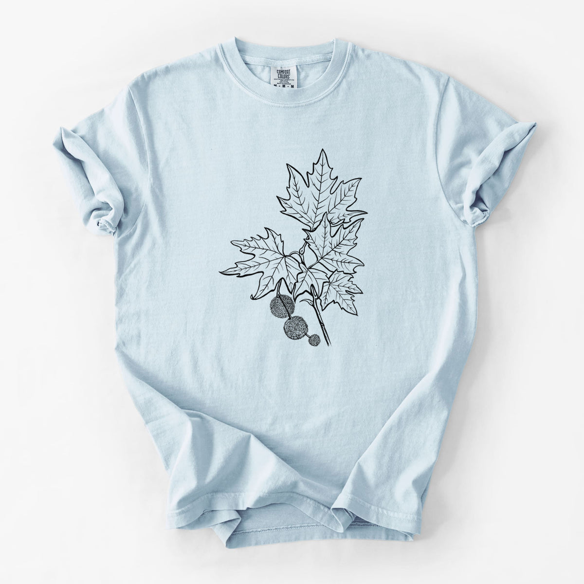 Chambray blue Comfort Colors t-shirt laid flat, printed with a black ink illustration of an oriental plane tree branch with lobed leaves and round seed balls.