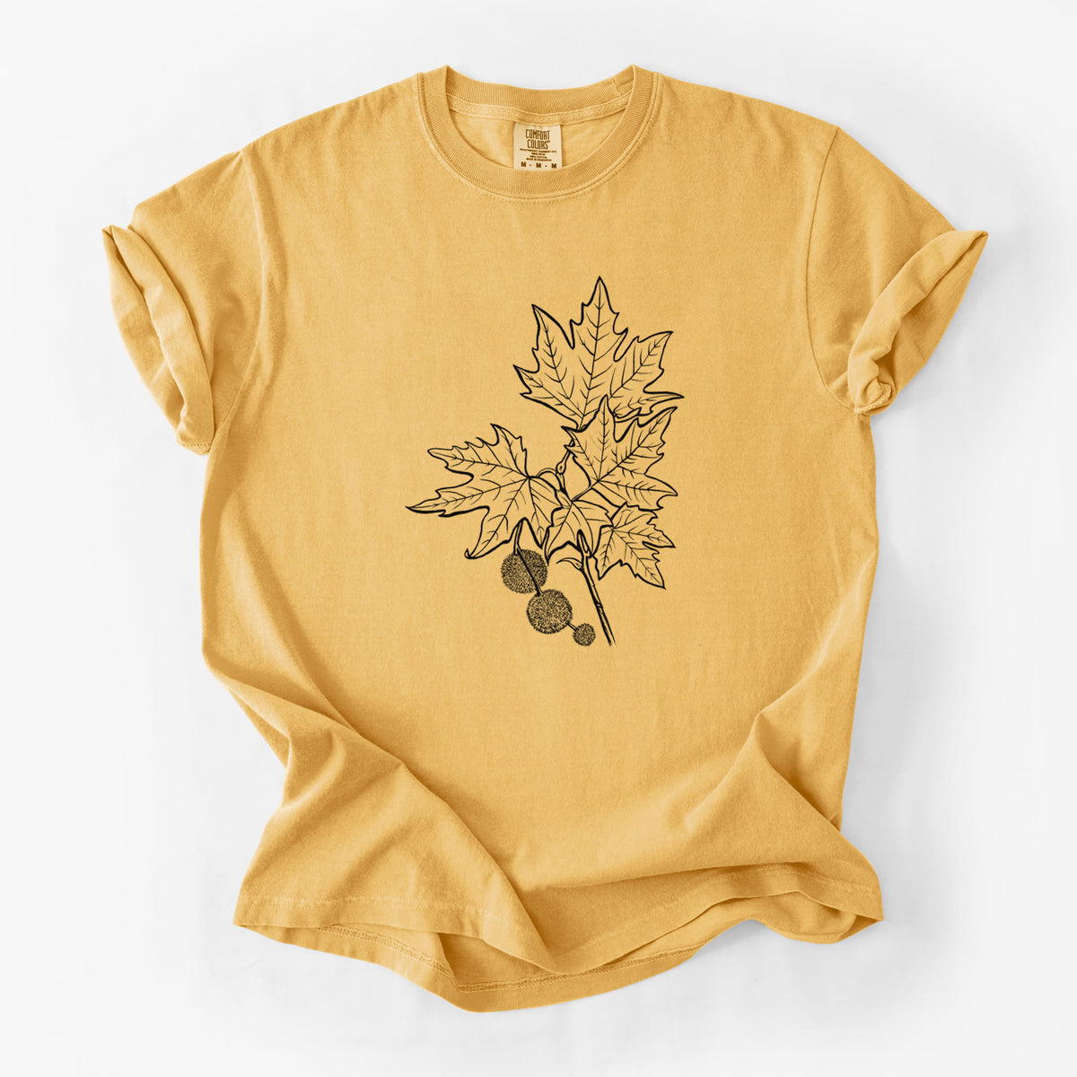 Golden wheat yellow Comfort Colors t-shirt laid flat, printed with a black ink illustration of an oriental plane tree branch with lobed leaves and round seed balls.