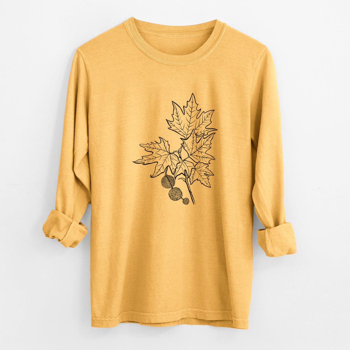 Golden wheat yellow Comfort Colors long sleeve shirt laid flat with the cuffs rolled, printed with a black ink illustration of an oriental plane tree branch with lobed leaves and round seed balls.