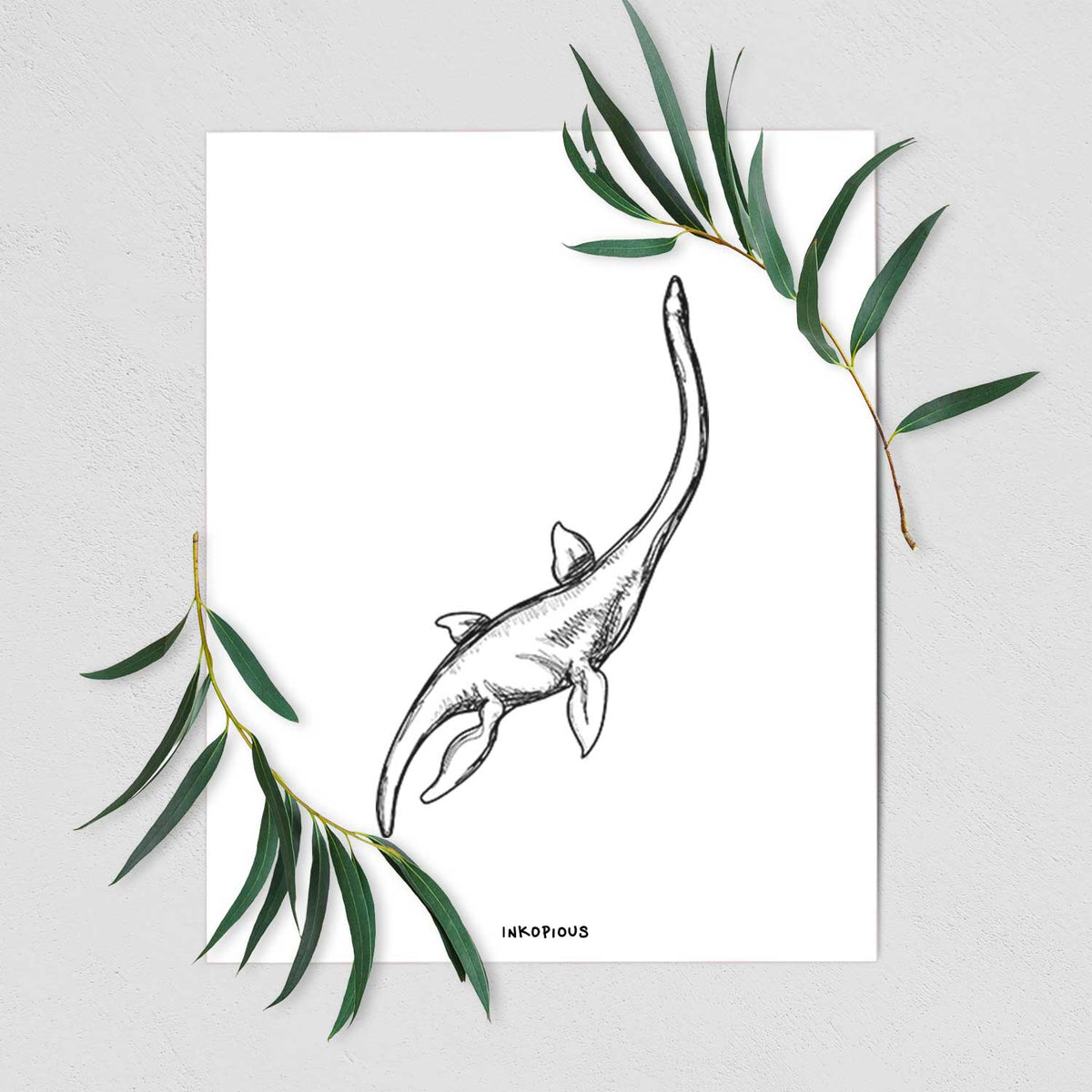 Art print of a black ink illustration of a long-necked plesiosaur swimming, shown with eucalyptus leaves.