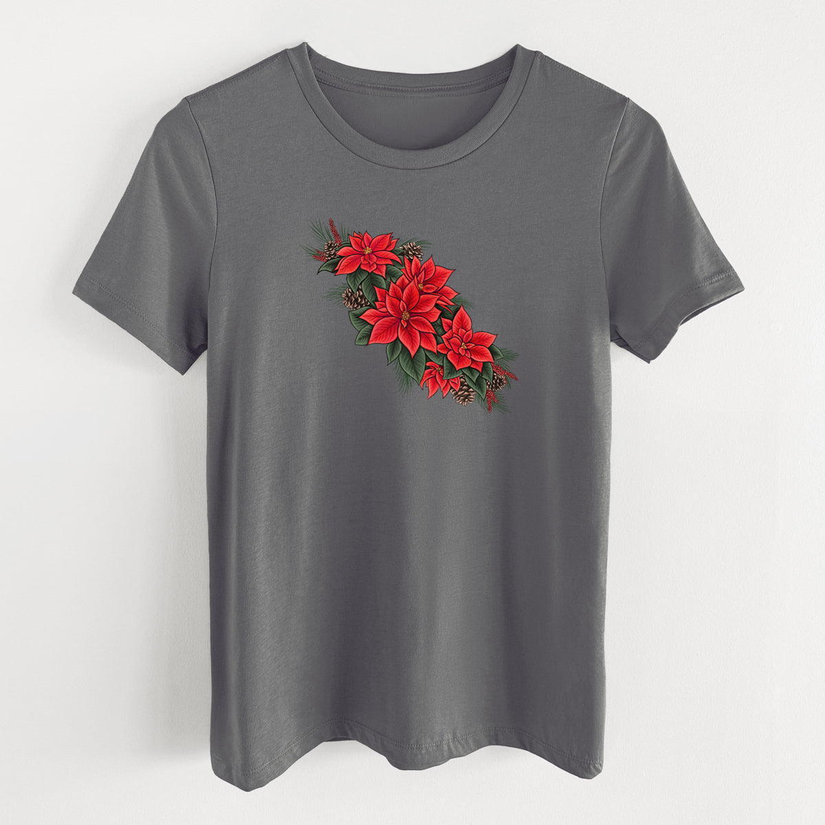 Asphalt women's relaxed fit cotton t-shirt laid flat, printed with a full-color illustration of red poinsettia flowers with pine greenery and pine cones.