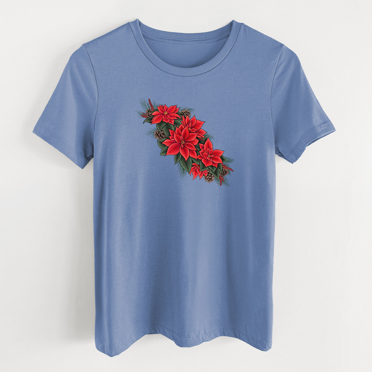 Blue bell women's relaxed fit cotton t-shirt laid flat, printed with a full-color illustration of red poinsettia flowers with pine greenery and pine cones.