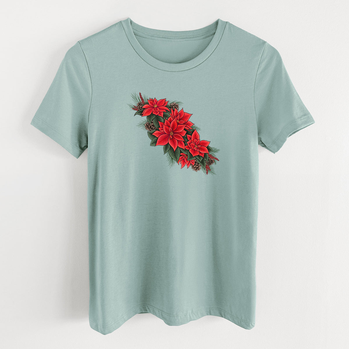 Dusty blue women's relaxed fit cotton t-shirt laid flat, printed with a full-color illustration of red poinsettia flowers with pine greenery and pine cones.