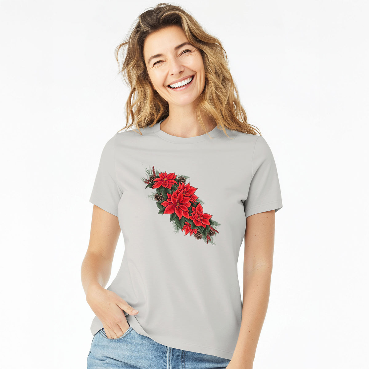 Woman wearing a lunar grey women's relaxed fit cotton t-shirt printed with a full-color illustration of red poinsettia flowers with pine greenery and pine cones.