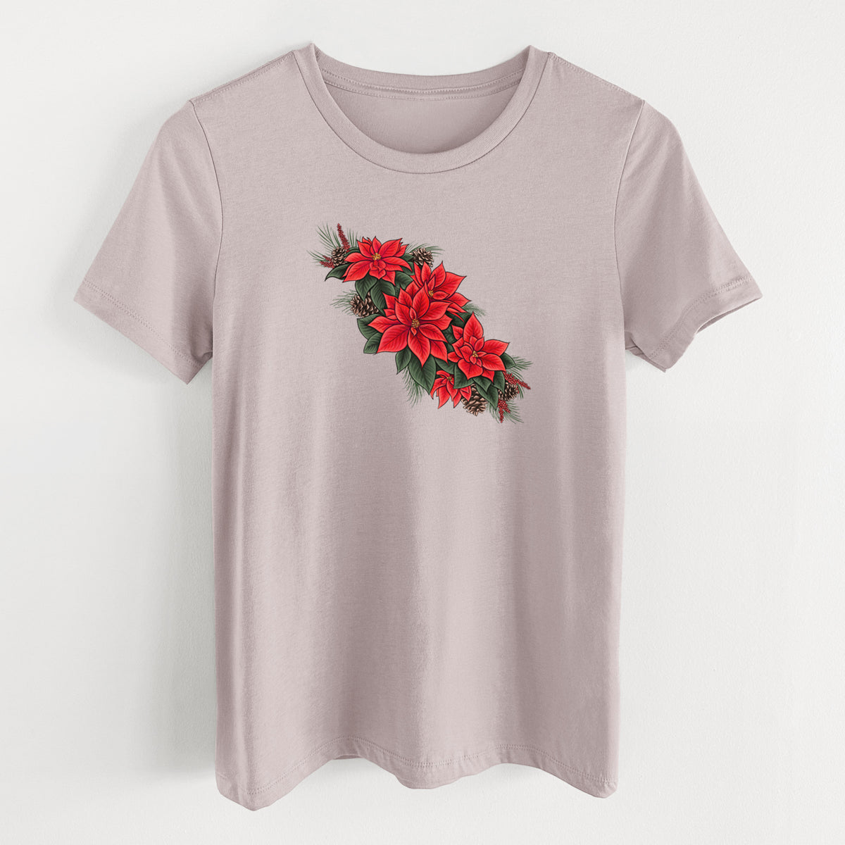 Pink gravel women's relaxed fit cotton t-shirt laid flat, printed with a full-color illustration of red poinsettia flowers with pine greenery and pine cones.