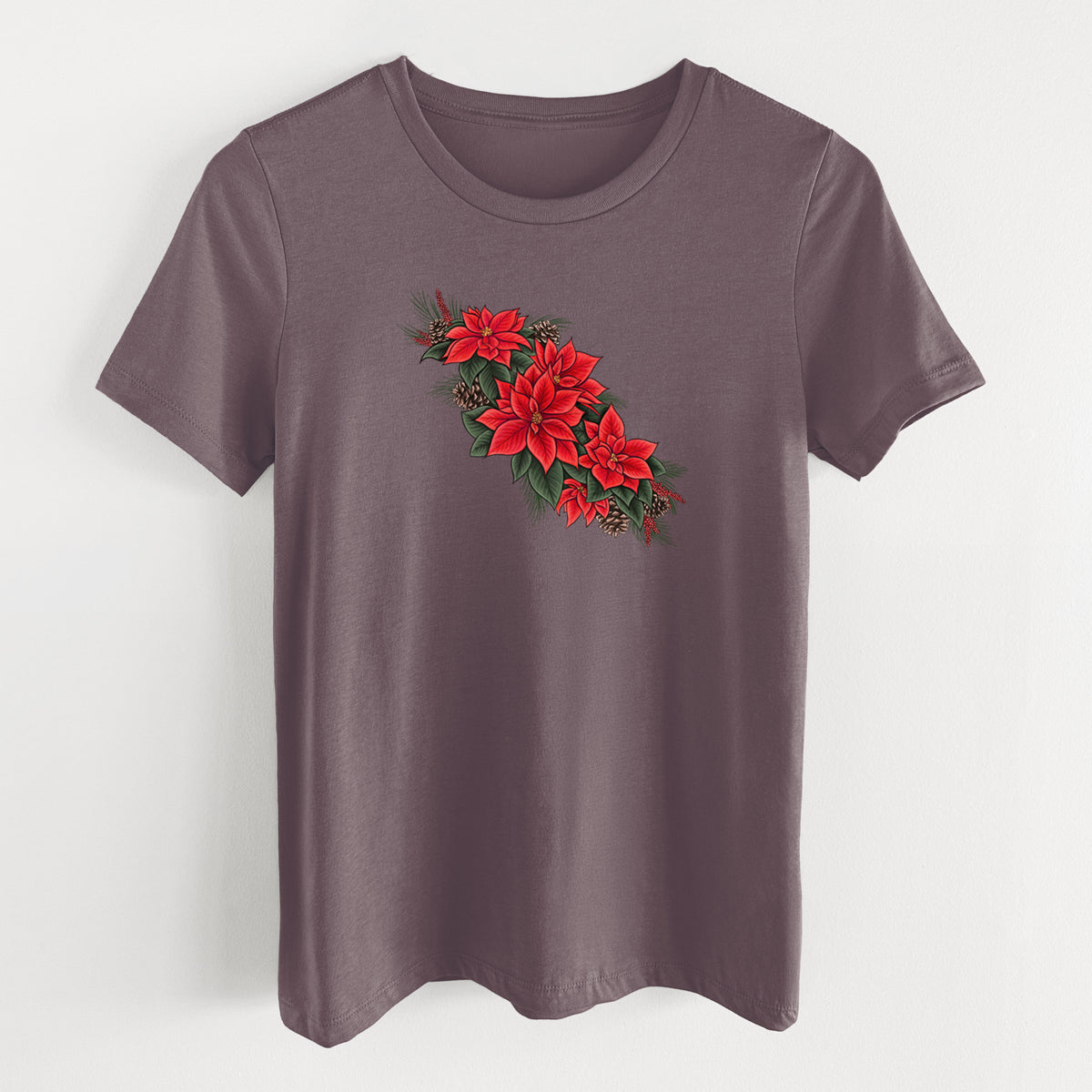 Purple storm women's relaxed fit cotton t-shirt laid flat, printed with a full-color illustration of red poinsettia flowers with pine greenery and pine cones.