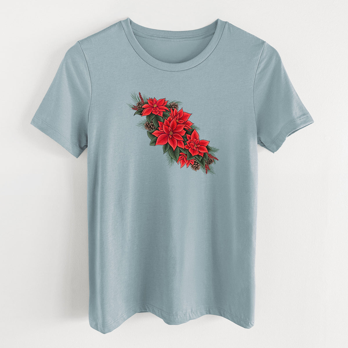 Vintage denim women's relaxed fit cotton t-shirt laid flat, printed with a full-color illustration of red poinsettia flowers with pine greenery and pine cones.