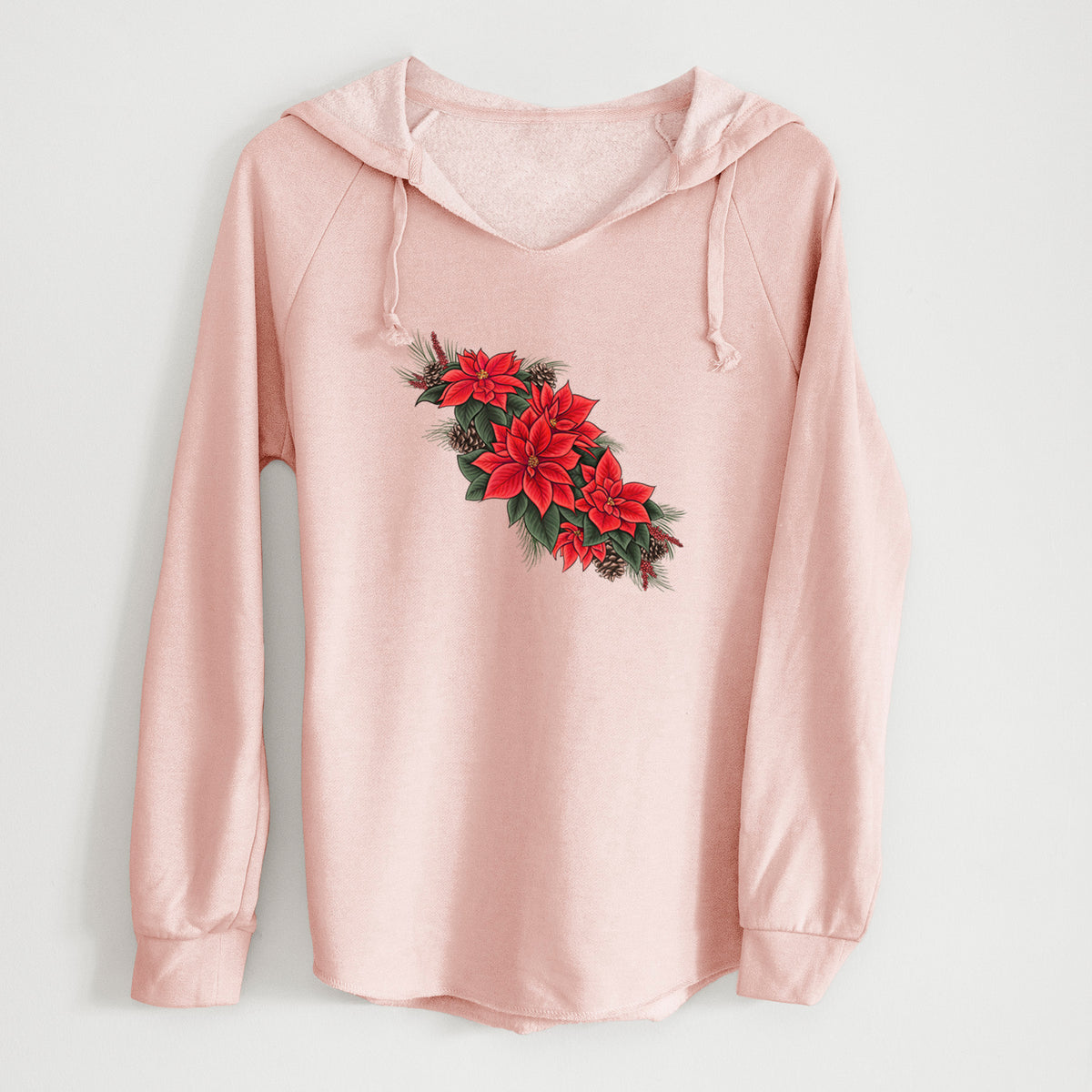 Blush pink women's Cali Wave hooded sweatshirt laid flat, printed with a full-color illustration of red poinsettia flowers with pine greenery and pine cones.