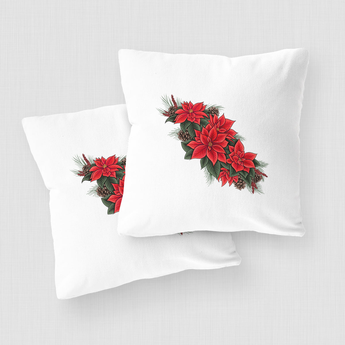 White pillow cover printed with a full-color illustration of red poinsettia flowers with pine greenery and pine cones, on a woven chair.