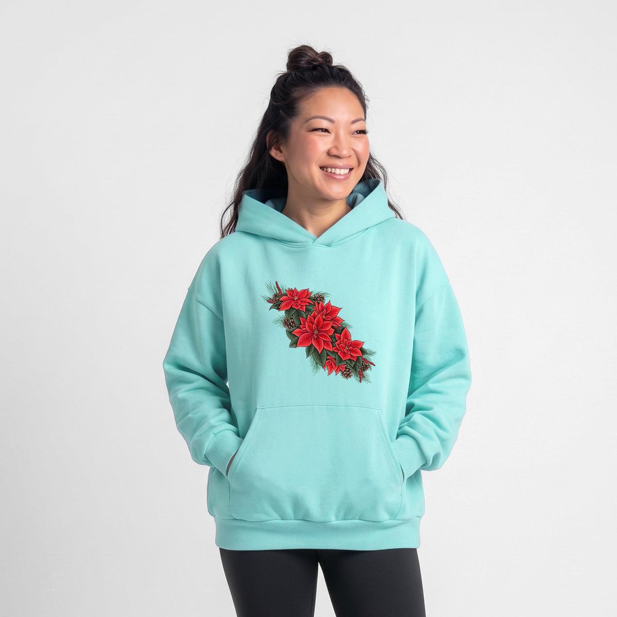 Female model wearing the Winter Poinsettias - Euphorbia pulcherrima - Statement Midweight Hoodie.