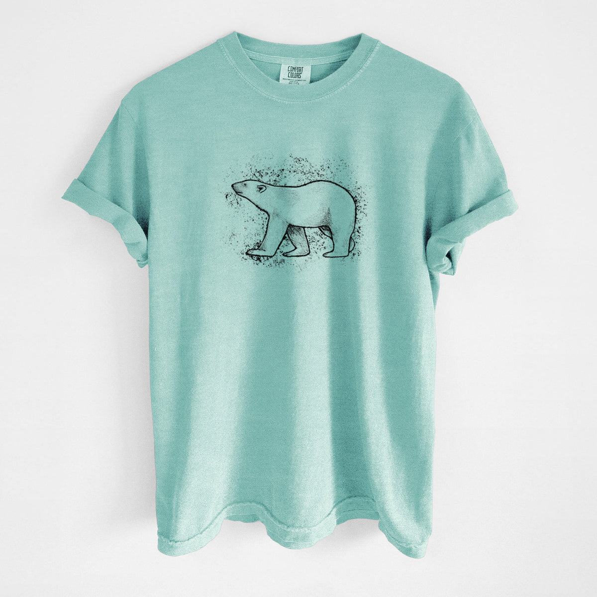 Chalky mint Comfort Colors t-shirt laid flat, printed with a black ink illustration of a polar bear walking across snow.