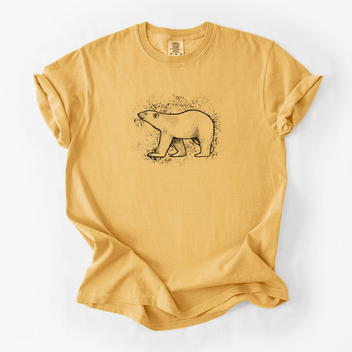 Golden wheat yellow Comfort Colors t-shirt laid flat, printed with a black ink illustration of a polar bear walking across snow.