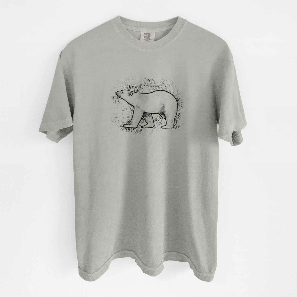 Sandstone beige Comfort Colors t-shirt laid flat, printed with a black ink illustration of a polar bear walking across snow.