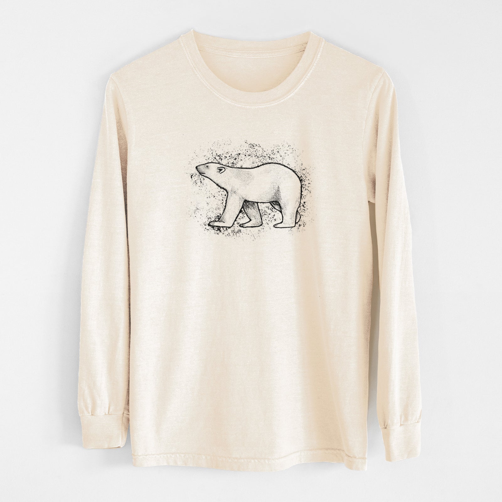 Ivory Comfort Colors long sleeve shirt laid flat, printed with a black ink illustration of a polar bear walking across snow.
