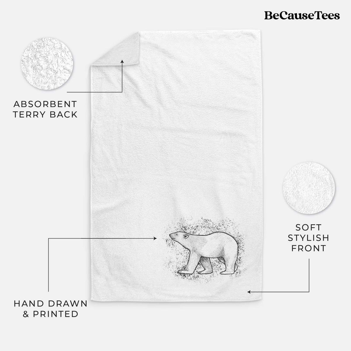 White hand towel printed with a black ink illustration of a polar bear walking across snow.