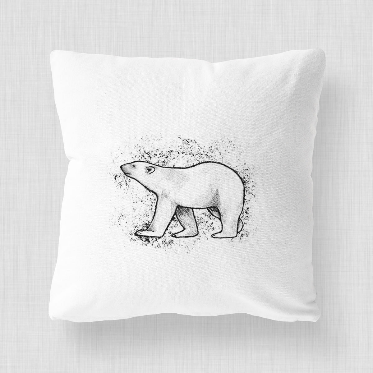 White pillow cover printed with a black ink illustration of a polar bear walking across snow.