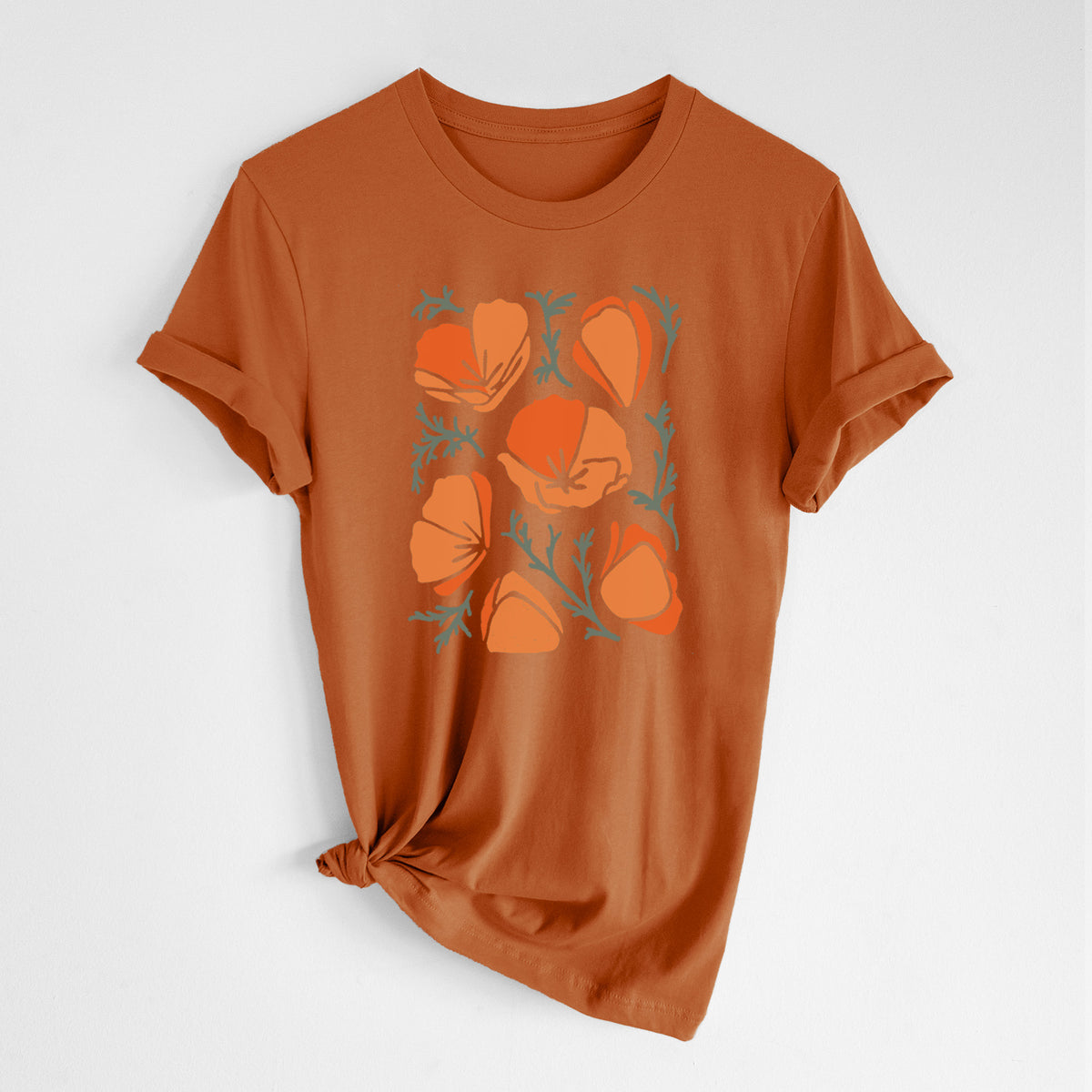 Autumn lightweight cotton t-shirt laid flat with the sleeves rolled, printed with a full-color illustration of orange California poppies with blue-green leaves.