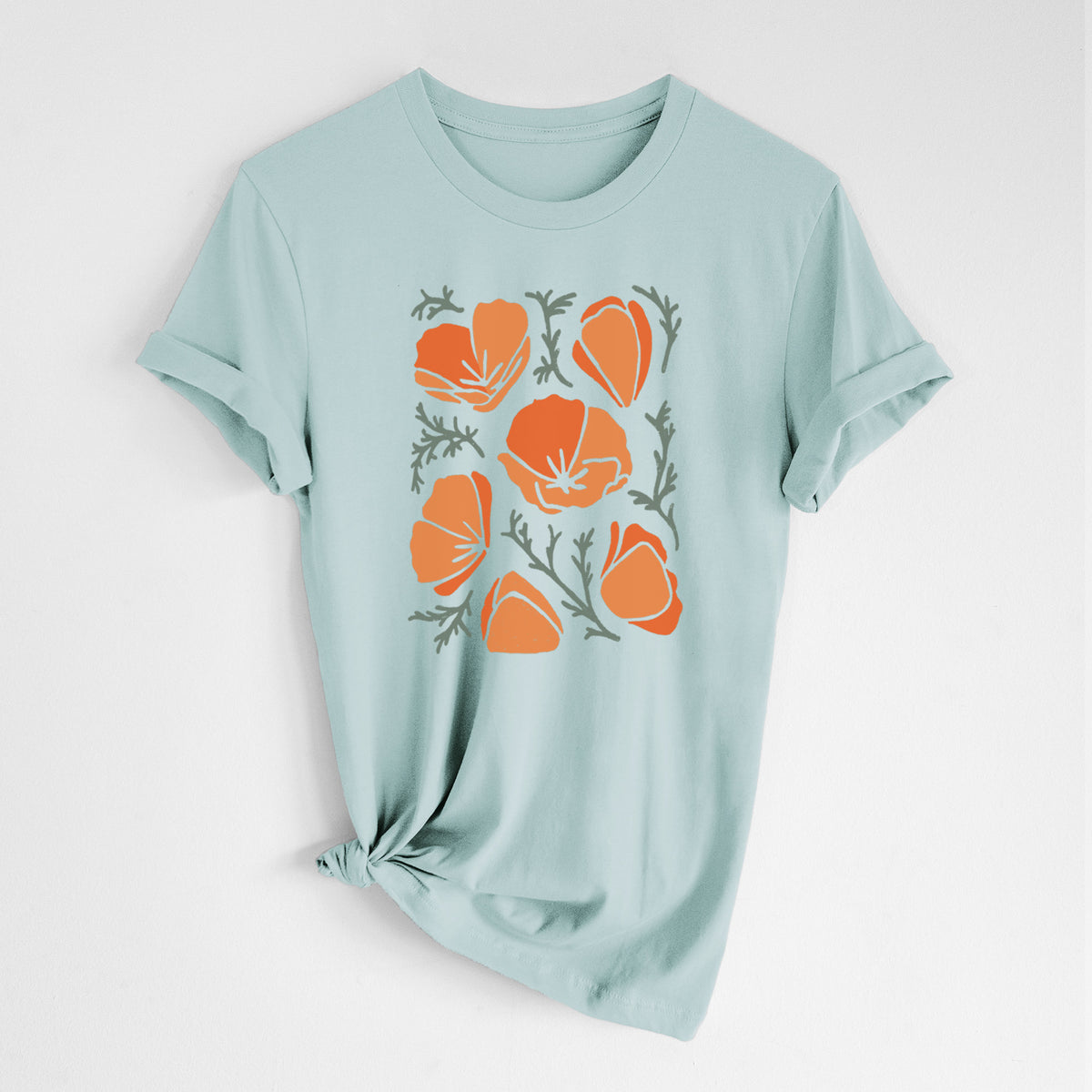 Dusty blue lightweight cotton t-shirt laid flat with the sleeves rolled, printed with a full-color illustration of orange California poppies with blue-green leaves.