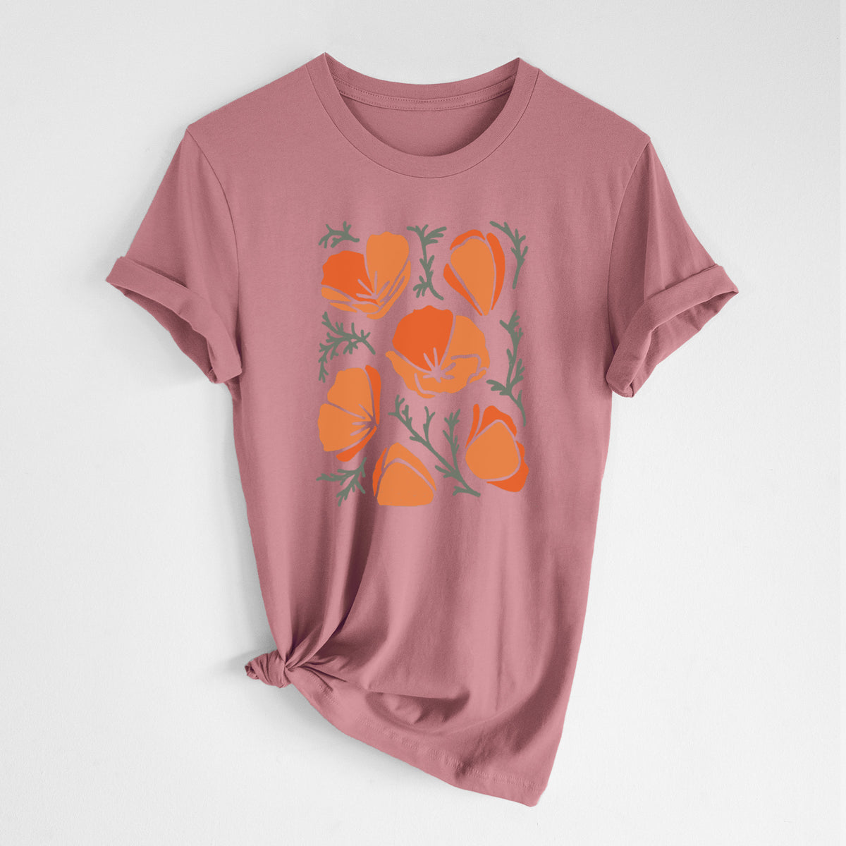 Mauve pink lightweight cotton t-shirt laid flat with the sleeves rolled, printed with a full-color illustration of orange California poppies with blue-green leaves.