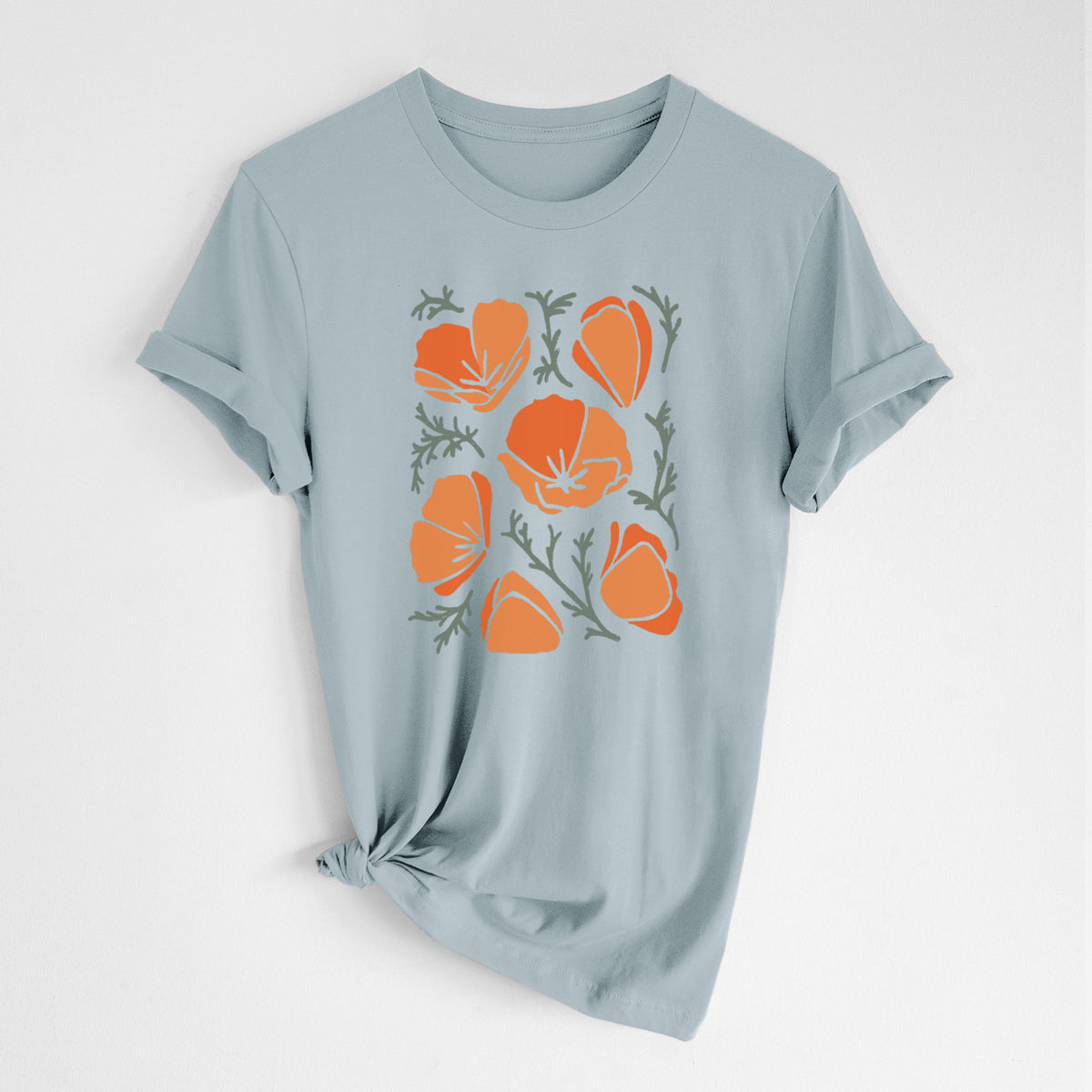 Vintage denim lightweight cotton t-shirt laid flat with the sleeves rolled, printed with a full-color illustration of orange California poppies with blue-green leaves.