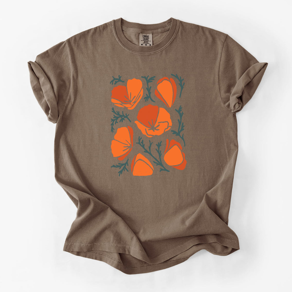 Espresso brown Comfort Colors t-shirt laid flat, printed with a full-color illustration of orange California poppies with blue-green leaves.