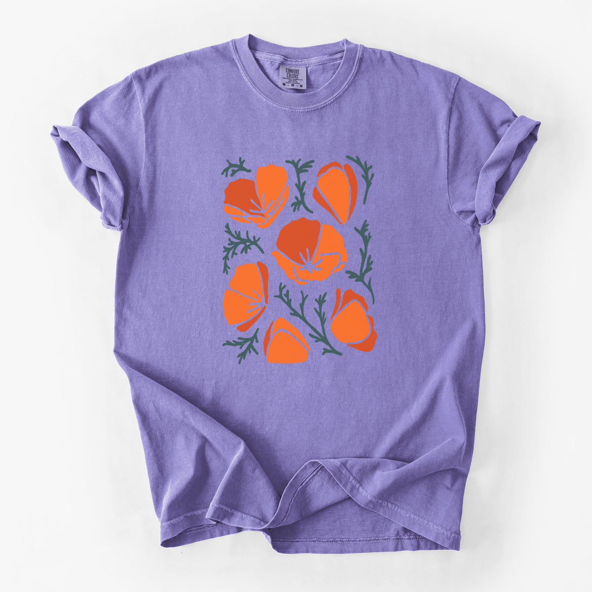Violet purple Comfort Colors t-shirt laid flat, printed with a full-color illustration of orange California poppies with blue-green leaves.