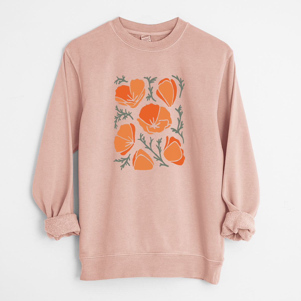 Dusty pink pigment dyed crewneck sweatshirt laid flat with the sleeves rolled, printed with a full-color illustration of orange California poppies with blue-green leaves.