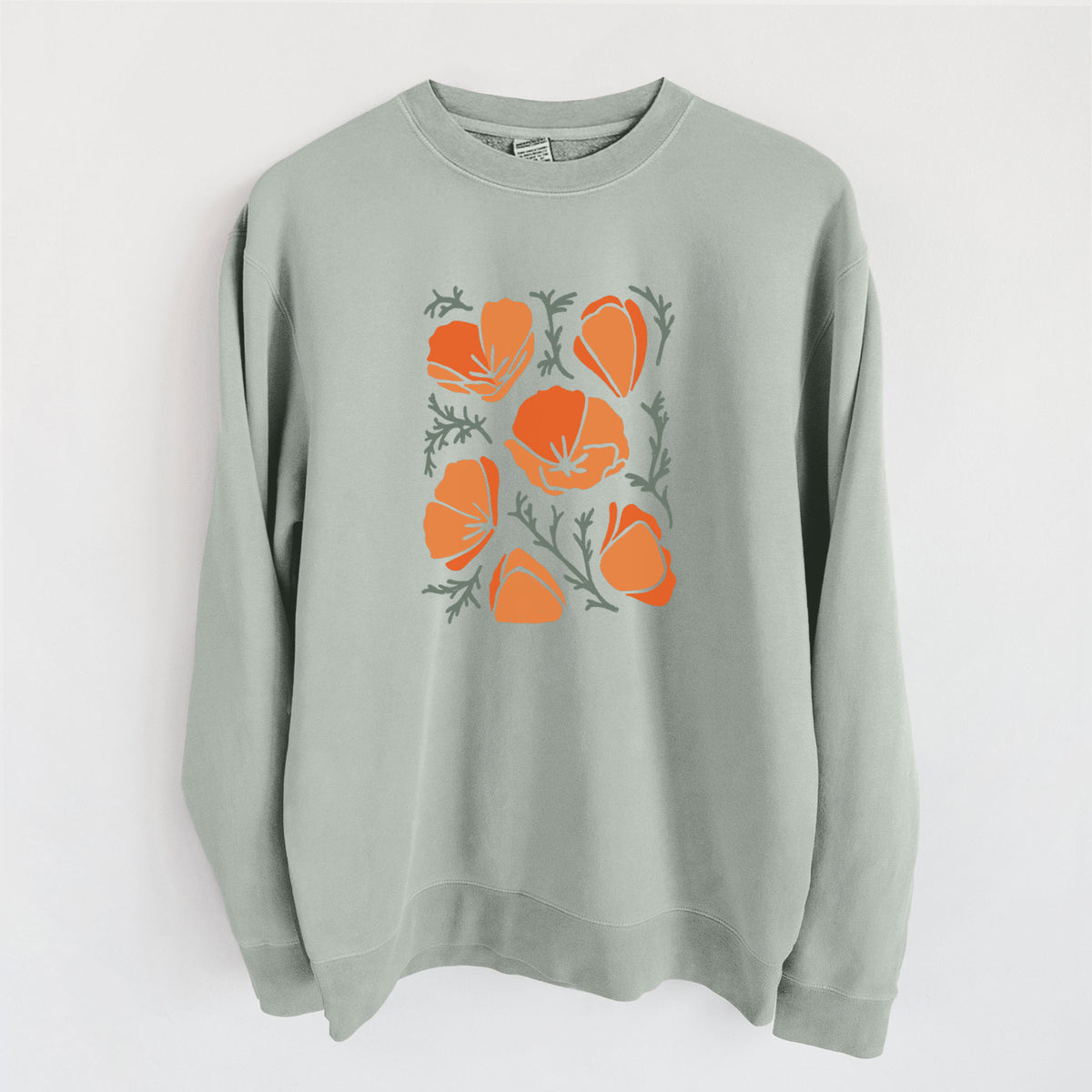 Sage green pigment dyed crewneck sweatshirt laid flat, printed with a full-color illustration of orange California poppies with blue-green leaves.