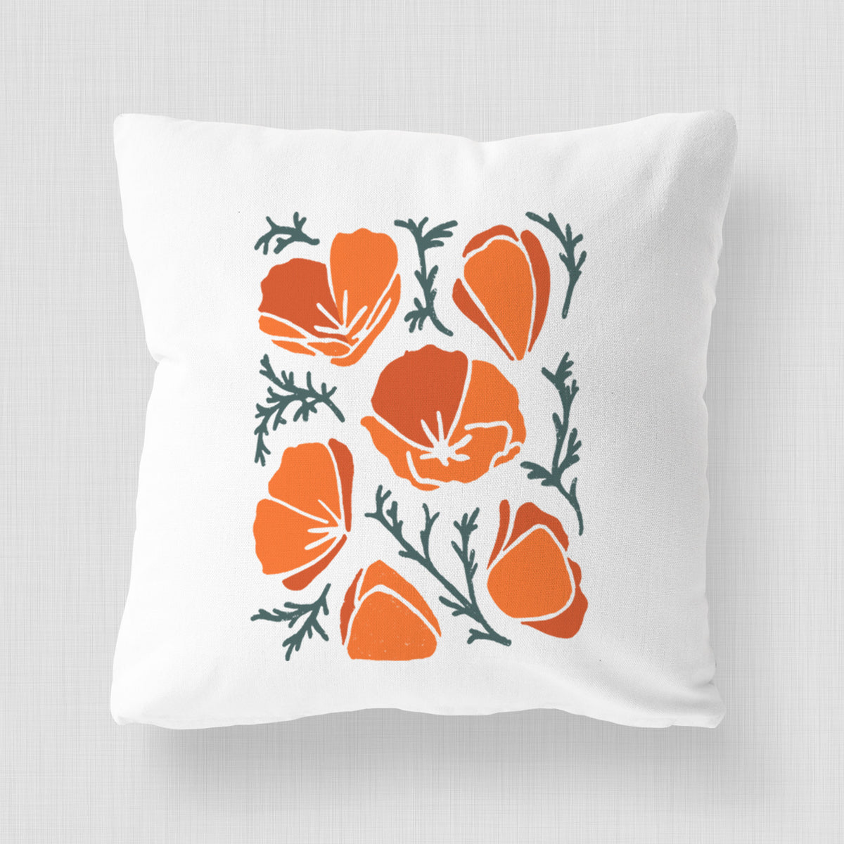 White pillow cover printed with a full-color illustration of orange California poppies with blue-green leaves.