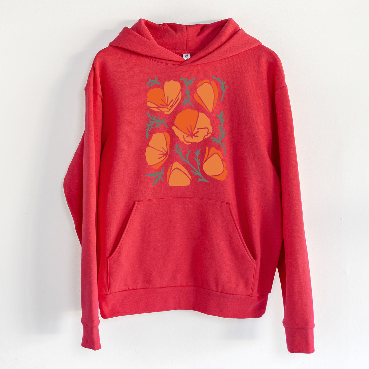 Poppy Vibes - Statement Midweight Hoodie in Cherry Red, hanging on a white wall, with a front kangaroo pocket and no drawcords.