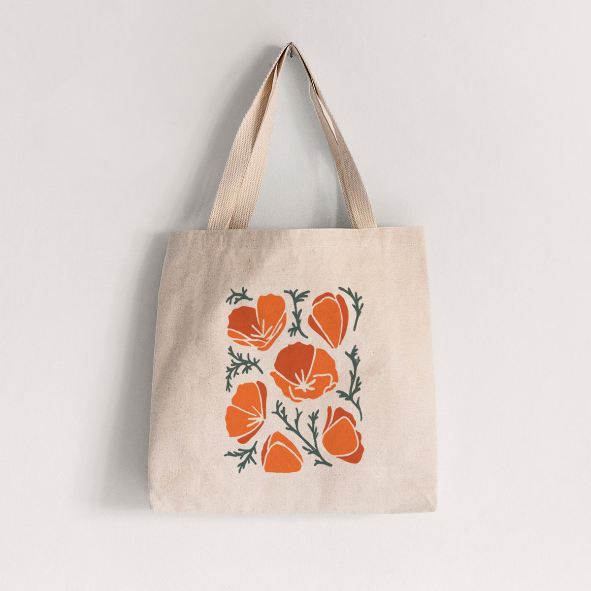 Natural canvas tote bag printed with a full-color illustration of orange California poppies with blue-green leaves.