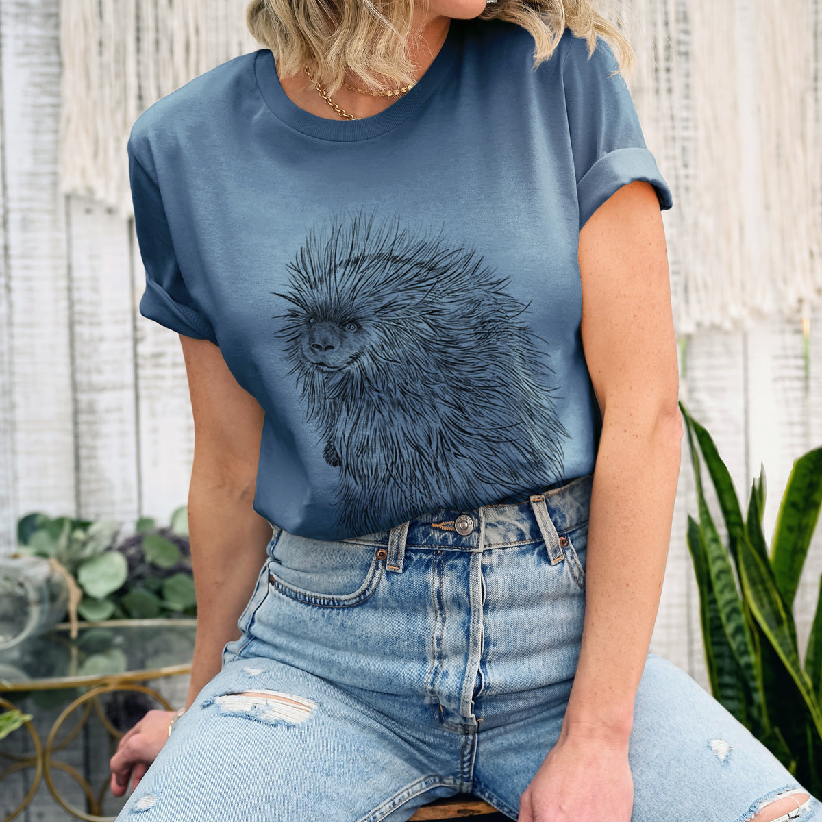 Woman wearing a steel blue lightweight cotton t-shirt printed with a detailed black ink illustration of a porcupine with its quills raised.